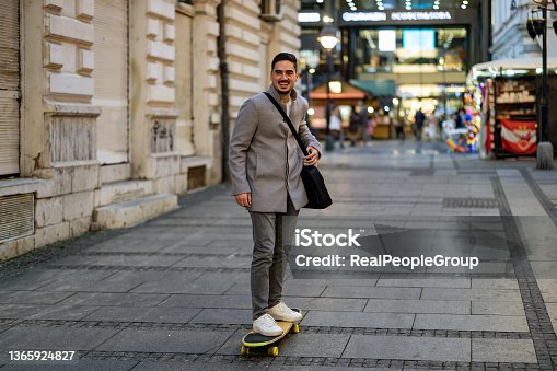 istock Young Businessman on a skateboard moving forward fast 1365924827