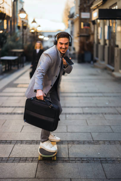 istock Young Businessman on a skateboard moving forward fast 1365924849