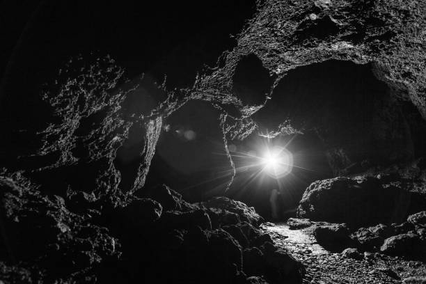 dark cave illuminated by a flashlight stock photo