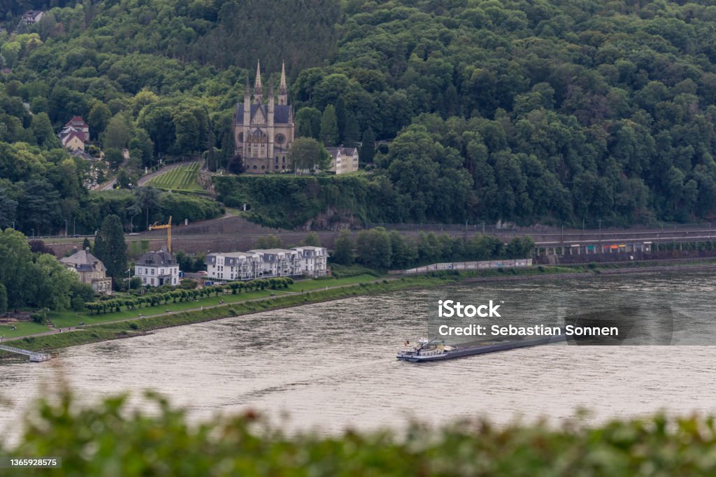 Aerial view at church of St Apollinaris surrounded by forest in front of the river rhine with boat, Remagen, Germany Remagen Stock Photo