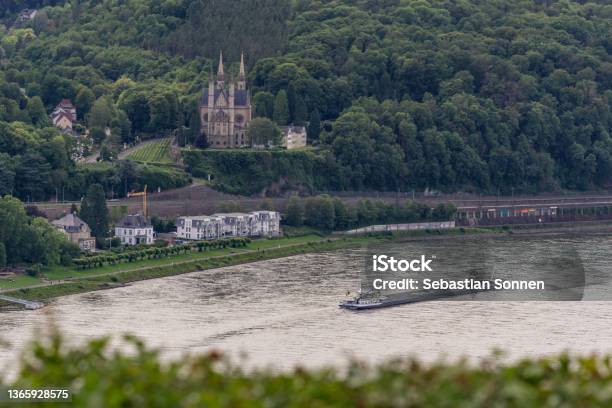 Aerial View At Church Of St Apollinaris Surrounded By Forest In Front Of The River Rhine With Boat Remagen Germany Stock Photo - Download Image Now