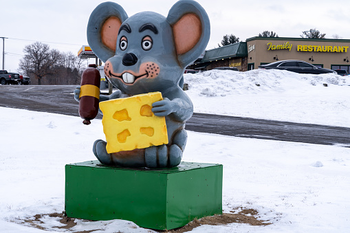 Mautson, Wisconsin - January 16, 2022: The famous Mautson mouse, holding cheese and a hot dog. Taken in winter