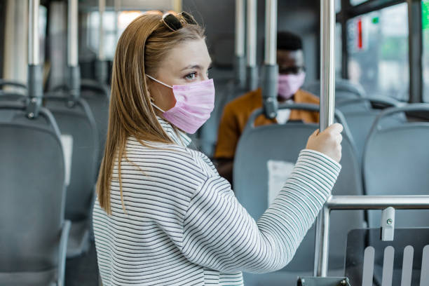 istock Female passenger in public transport with a protective face mask 1365929607