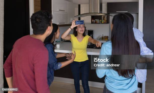 Happy Friends Playing Heads Up At Home Stock Photo - Download Image Now - Party Game, Charades, Mobile App