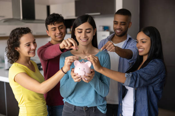 Group of flat mates making a collection for their home budget