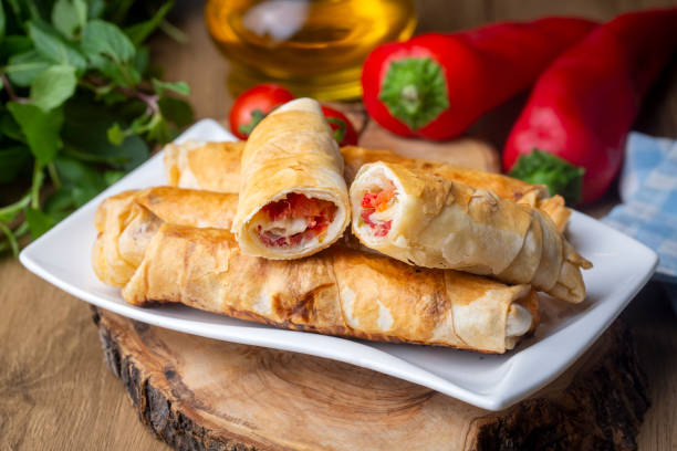 istock Turkish Pacanga Boregi with pastirma (pastrami) and cheddar (melted) cheese. Pastirmali Borek 1365931182