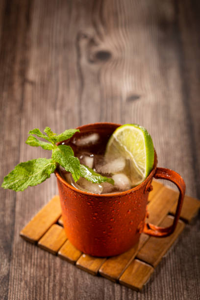 istock Moscow mule cocktail in copper mug on the table. 1365931317