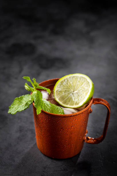 istock Moscow mule cocktail in copper mug on the table. 1365931362