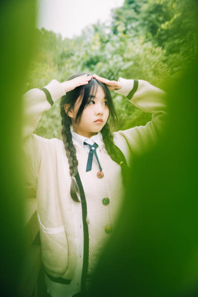 istock Young asian girl with leaves 1365936173