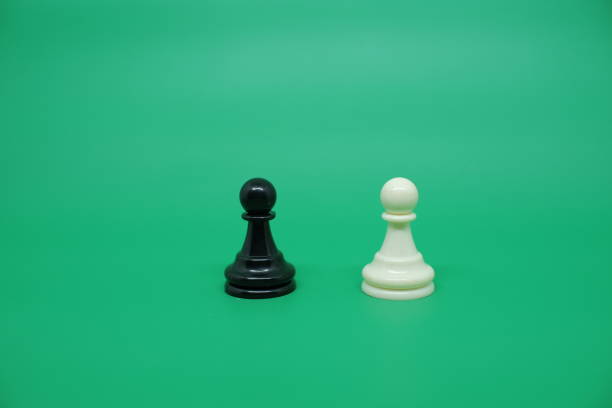 Two chess pawns stand opposite each other. White pawn and black pawns, confrontation concept. 3D rendering isolated on white background