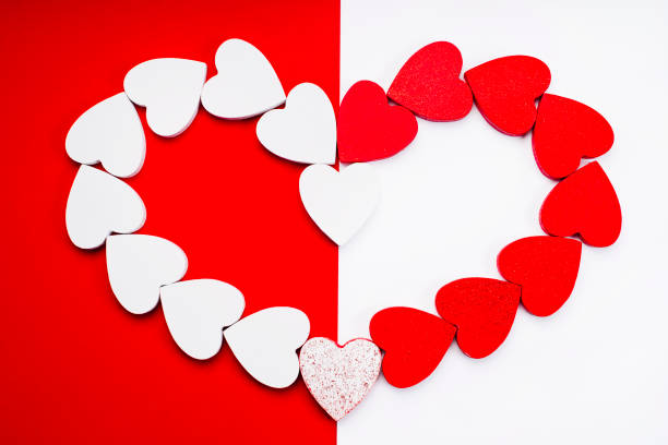 istock Love triangle or polygamy, polygamous relationship .Happy Valentine Day.Concept of polygamy love and February holiday.Red and white hearts on a mixed background red and white.Mixed love. 1365940997