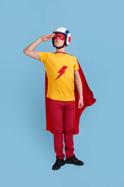 istock Funny superhero in helmet saluting 1365941087