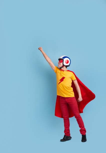 istock Funny courageous superhero in hardhat in studio 1365941095