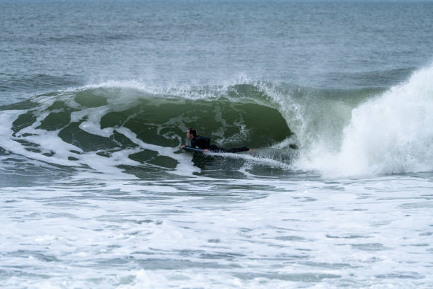 istock Bodyboarder performing a tube trick 1365949695