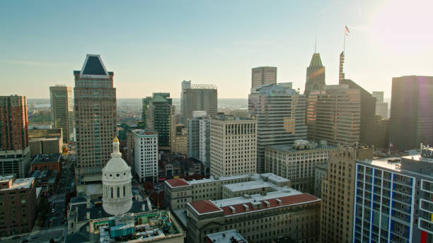 Aerial shot of downtown office towers in Baltimore, Maryland and the dome of City Hall late in the afternoon on a cloudless evening in Fall. \n\nAuthorization was obtained from the FAA for this operation in restricted airspace.
