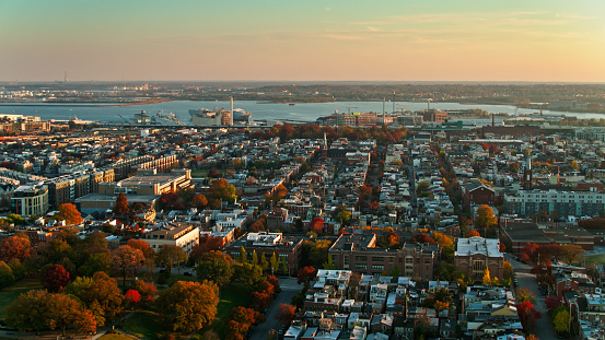 Aerial shot of Baltimore, Maryland at sunset, looking over Federal Hill Park and Riverside towards the port. 
   
Authorization was obtained from the FAA for this operation in restricted airspace.