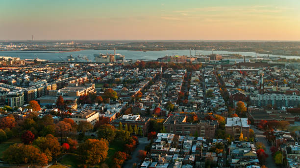 Fall Colors in Federal Hill and Riverside, Baltimore at Sunset - Aerial Aerial shot of Baltimore, Maryland at sunset, looking over Federal Hill Park and Riverside towards the port. 
   
Authorization was obtained from the FAA for this operation in restricted airspace. baltimore maryland stock pictures, royalty-free photos & images