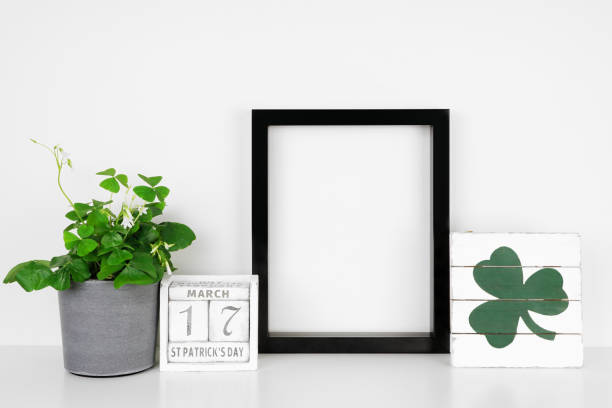 istock Mock up black frame with St Patricks Day decor on a white shelf against a white wall 1365953449