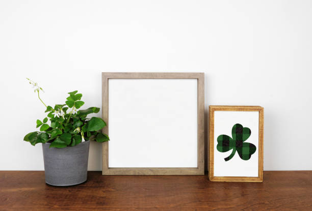 Mock up wood frame with St Patricks Day decor on a wood shelf against a white wall