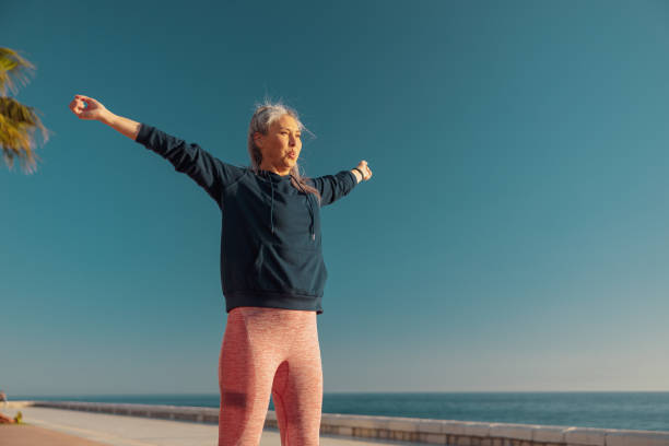 istock Slender lady actively exercising by the waterfront 1365955771