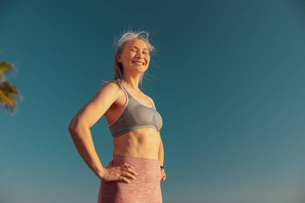 istock Smiling woman resting by the waterfront after training 1365955773