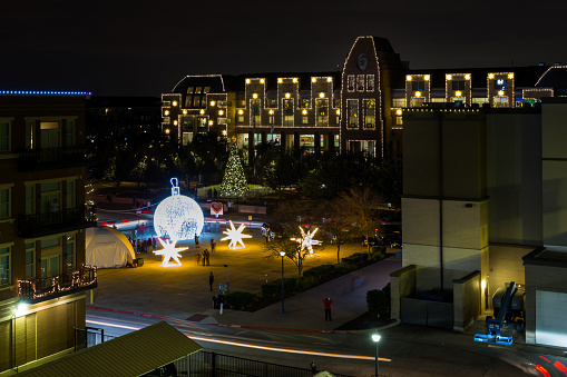 Frisco, Texas, USA - December 17th, 2021:  Downtown street, Christmas tree and City Hall beautifully illuminated for Christmas