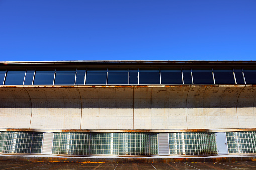 Rusty building exterior against clear sky.