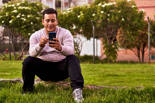istock sending a very concentrated message is a man sitting in a park 1365964618