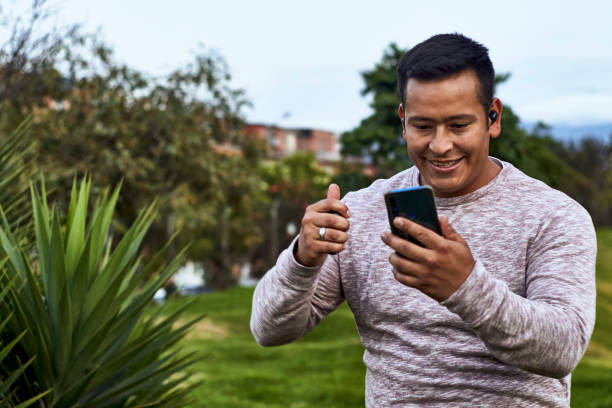 istock a man dancing while talking to his family on his cell phone 1365964663