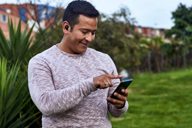 a man uses his smart devices outside his house