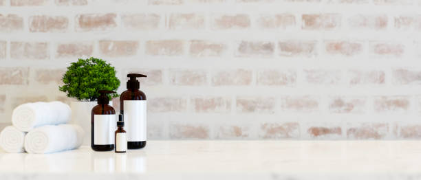 istock Set of bath products with towels and copy space on tabletop over white brick wall 1365965480