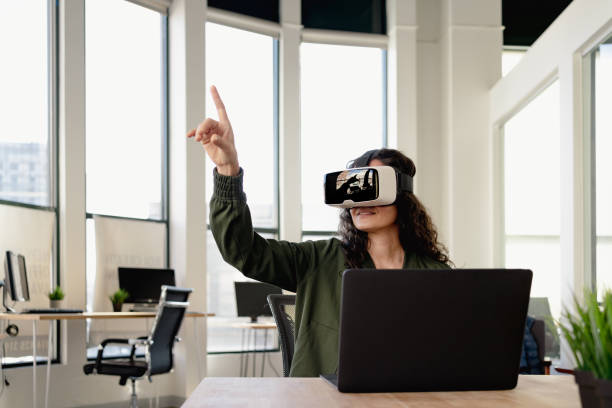 Woman in office wearing VR glasses at meeting Woman in office wearing VR glasses at meeting metaverse stock pictures, royalty-free photos & images