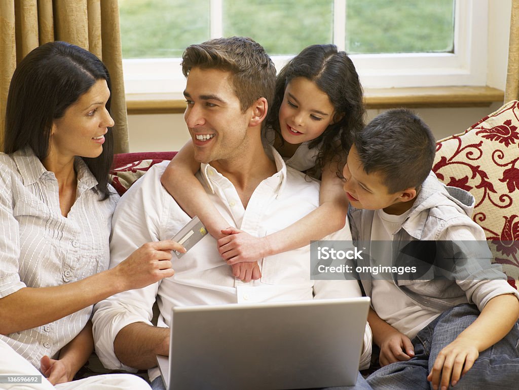 A Hispanic young family doing some online shopping Hispanic family shopping online together Latin American and Hispanic Ethnicity Stock Photo