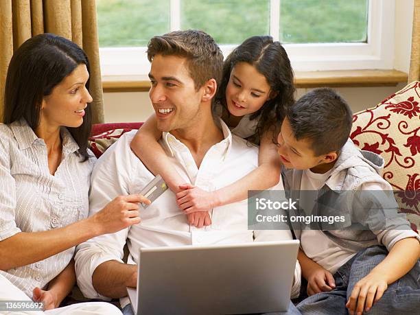 A Hispanic Young Family Doing Some Online Shopping Stock Photo - Download Image Now - Latin American and Hispanic Ethnicity, Credit Card, Family