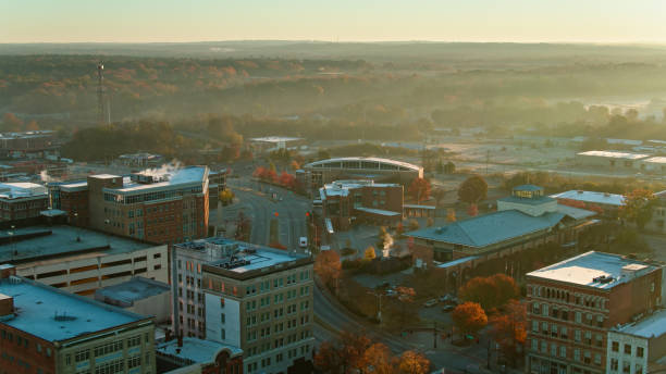 istock Fog Lying Over Trees Beyond Rooftops of Macon, GA - Aerial 1365967518