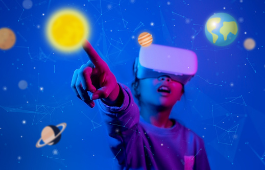 Girl wearing virtual reality headset or vr glasses, Pointing to the sun, Future technology concept.