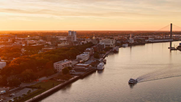 istock Riverboat Passing Downtown Savannah at Sunset - Aerial 1365968389