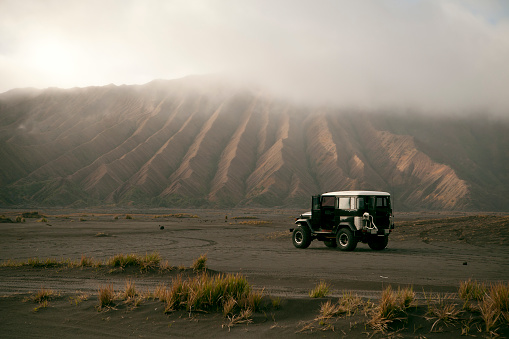 Off road vehicle on the volcanic caldera at Mount Bromo.