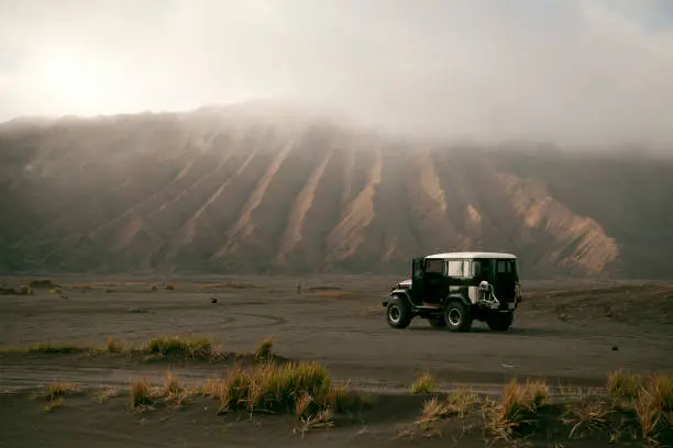 Off road vehicle on the volcanic caldera at Mount Bromo.