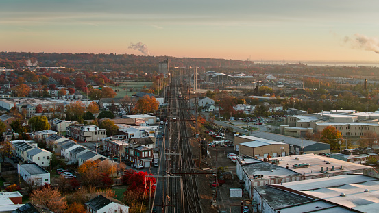Drone shot of a passenger train in Wilmington, Delaware at sunrise on a Fall morning. \n\nAuthorization was obtained from the FAA for this operation in restricted airspace.