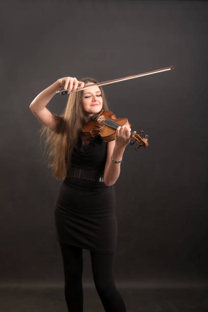 istock violinist in a black dress 1365972964