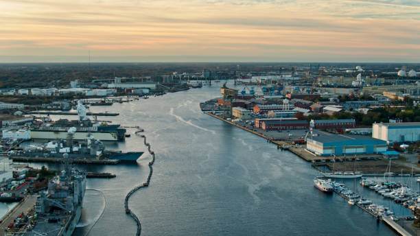 Drone shot of huge military vessels in the Norfolk Navy Yard in Virginia at sunrise.
