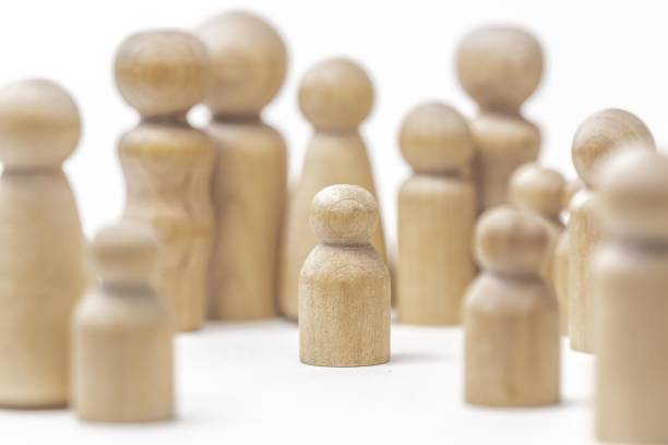 istock Wooden Figurine Surrounded by Peers 1365973155