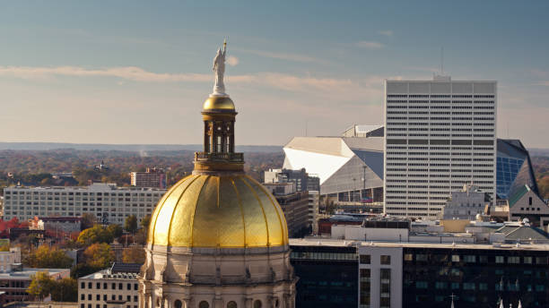 Statue on Dome of Georgia State Capitol and Downtown Atlanta Buildings - Drone Shot Drone shot of the Georgia State Capitol Building in Atlanta on a sunny afternoon in Fall. georgia us state photos stock pictures, royalty-free photos & images