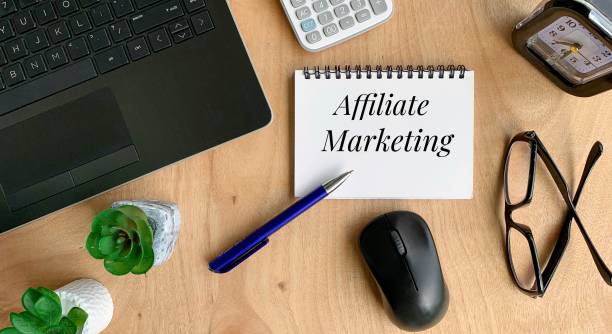 Affiliate marketing words on a notebook. With pen, mouse, calculator, plant, laptop and brown table background. Online business concept Affiliate marketing words on a notebook. With pen, mouse, calculator, plant, laptop and brown table background. Affiliate Marketing stock pictures, royalty-free photos & images