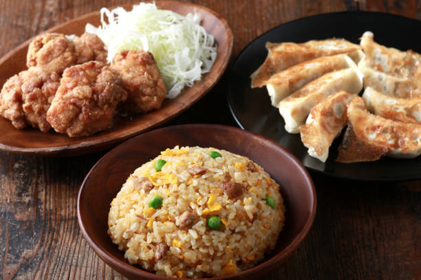 Fried rice, dumplings and fried chicken stock photo