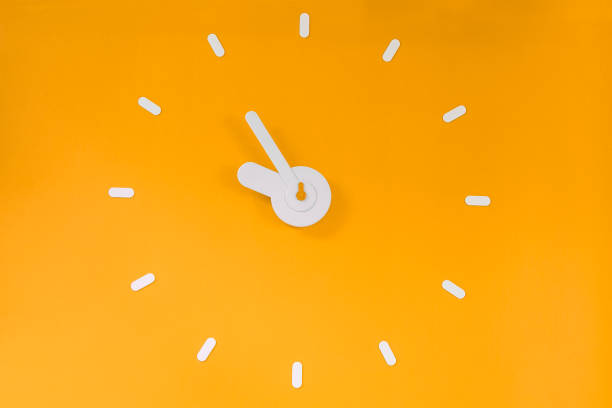 Wall clock on the blue wall with copy space.\n5 o'clock