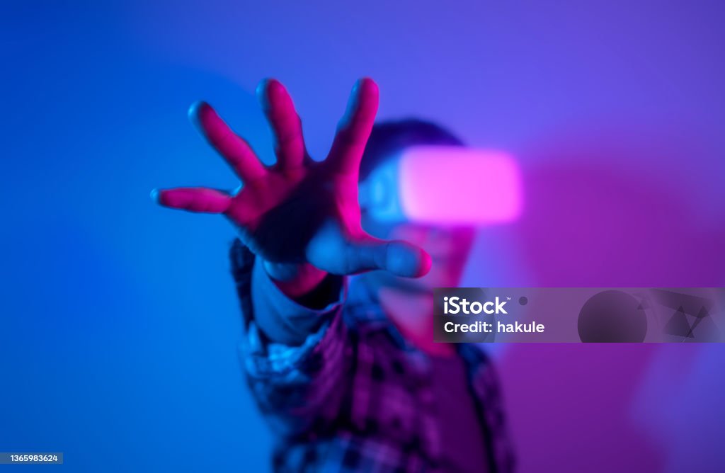 Man experiencing virtual reality eyeglasses headset,  stock photo Metaverse Stock Photo