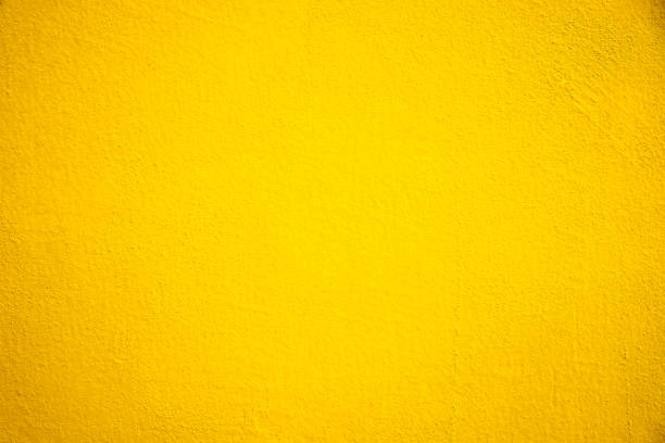istock Abstract weathered texture stained old stucco light yellow color and aged paint concrete wall background 1365983920