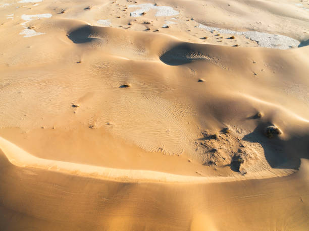 istock Big red dune in foreground with smaller dunes flowing behind, drone view 1365983999